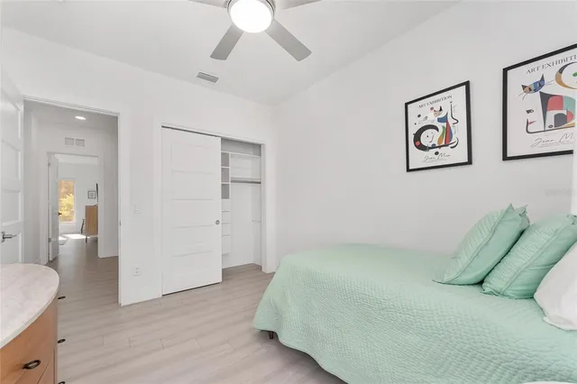 a bedroom with furniture and a flat screen tv