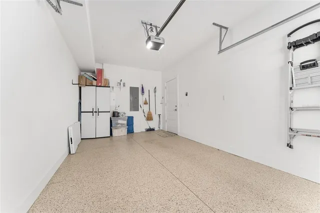 a view of a swimming pool with an outdoor seating and a floor to ceiling window