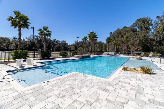 a view of a building with a swimming pool and sitting area