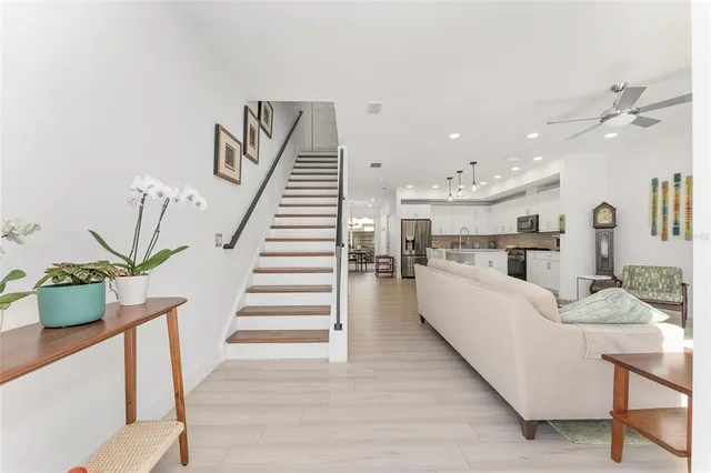 a living room with furniture and a dining table