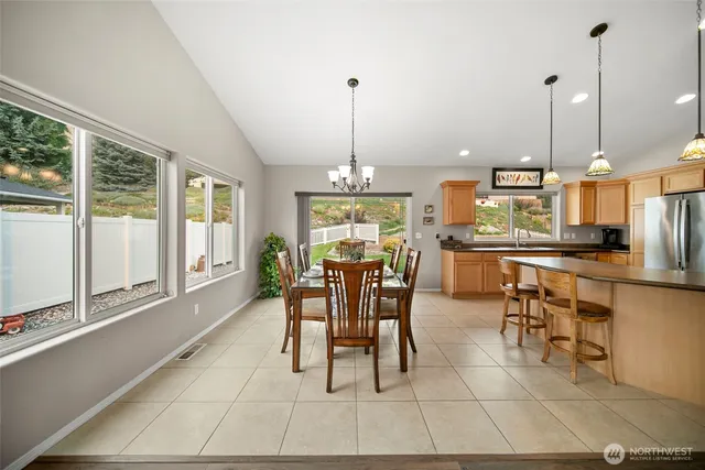 a dining room filled with furniture and large windows