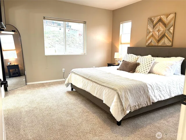 a bed sitting in a bedroom next to a window