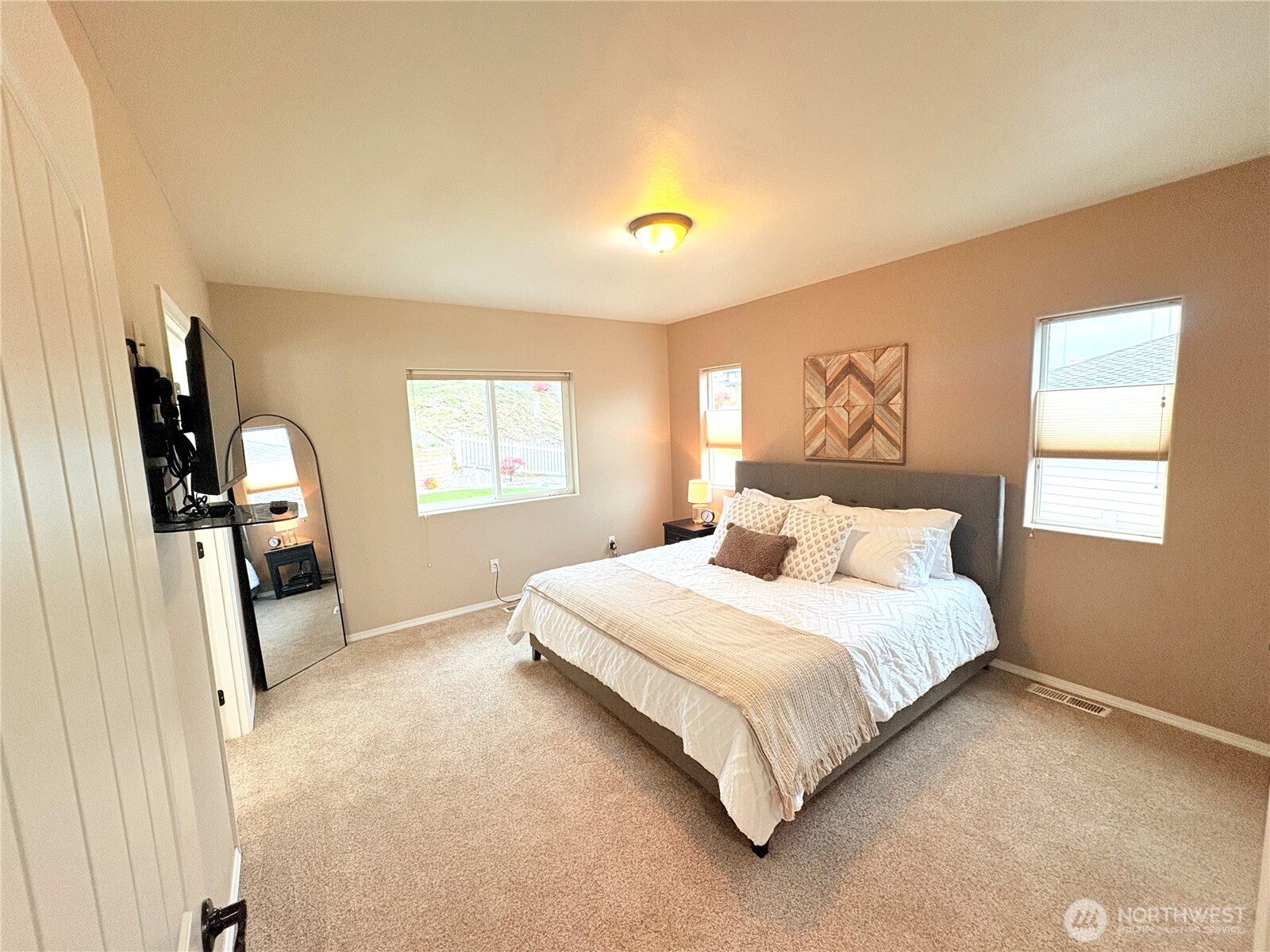 2012 Linville Drive Wenatchee, WA 98801 - Photo 15 of 40 a bedroom with a bed flat screen tv and a window