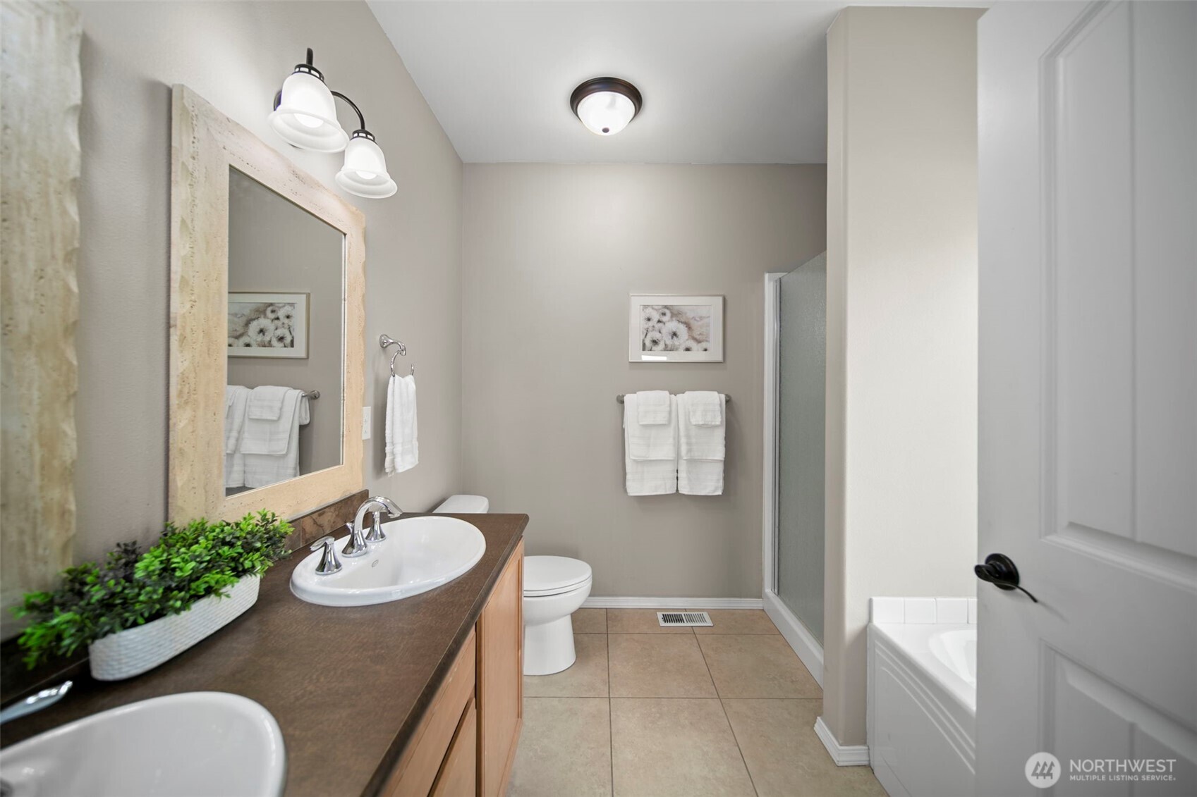 2012 Linville Drive Wenatchee, WA 98801 - Photo 17 of 40 a bathroom with a granite countertop sink and a mirror