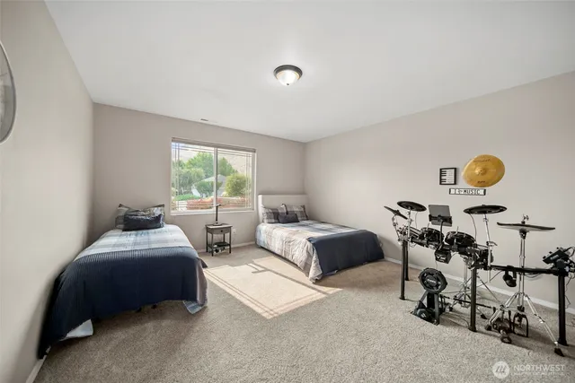 a bedroom with two beds and a window