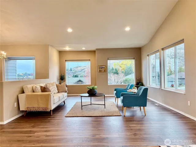 a living room with fireplace furniture and a large window