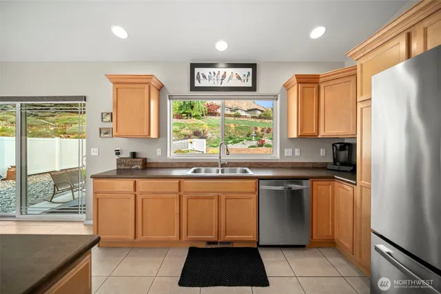 a kitchen with stainless steel appliances a stove sink and cabinets