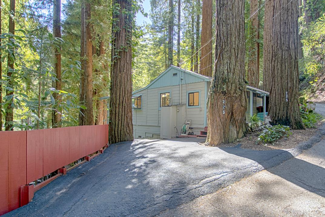 225 Glengarry Road Felton, CA 95018 - Photo 25 of 35 a brick house next to a yard with large trees