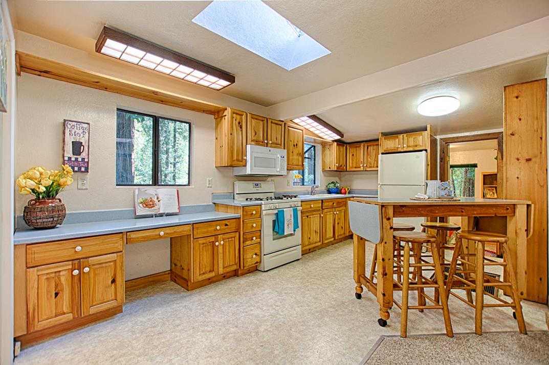 225 Glengarry Road Felton, CA 95018 - Photo 4 of 35 a kitchen with a sink stove and cabinets