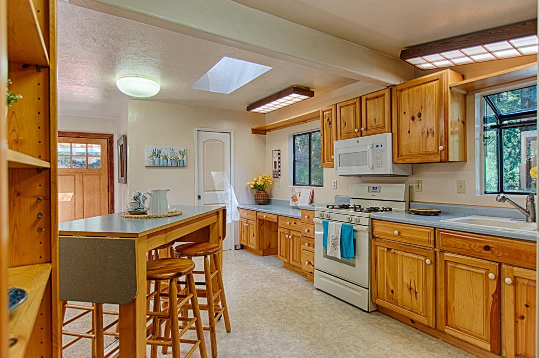 225 Glengarry Road Felton, CA 95018 - Photo 7 of 35 a kitchen with wooden cabinets and center island