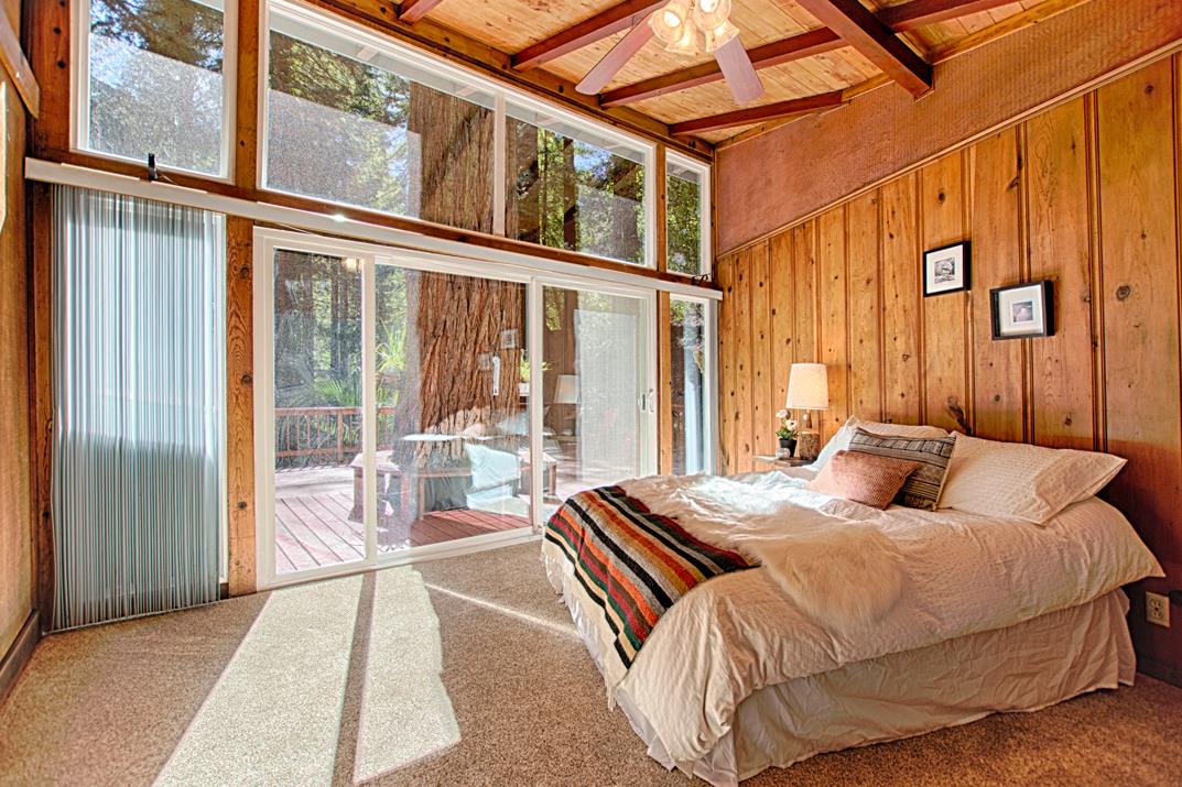 225 Glengarry Road Felton, CA 95018 - Photo 9 of 35 a bedroom with a bed and glass door
