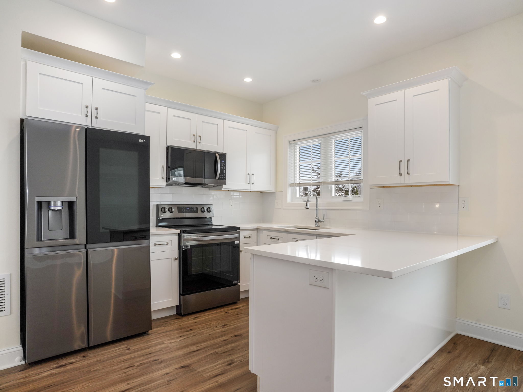 6 Beacon Square, Unit 7 Fairfield, CT 06825 - Photo 17 of 33 a kitchen with stainless steel appliances granite countertop a sink stove and refrigerator