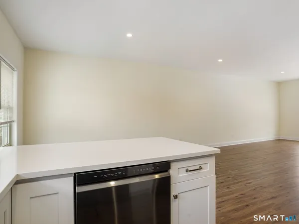 a living room with wooden floors and white walls