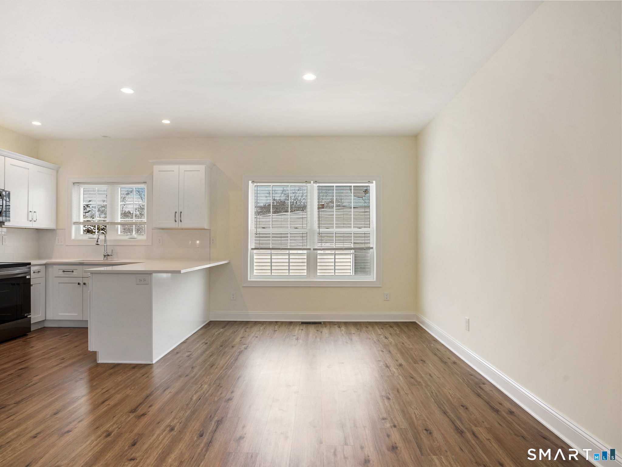 6 Beacon Square, Unit 7 Fairfield, CT 06825 - Photo 19 of 33 a living room with wooden floors and white walls