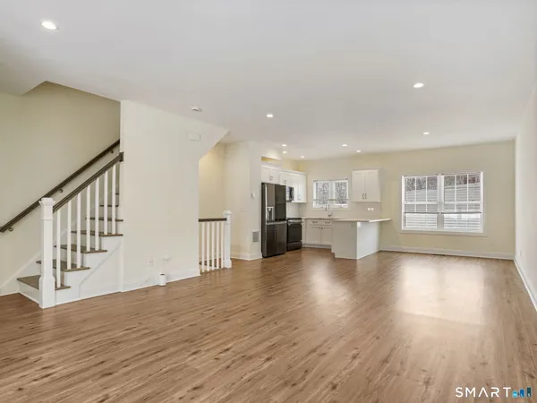 a view of a kitchen with wooden floor