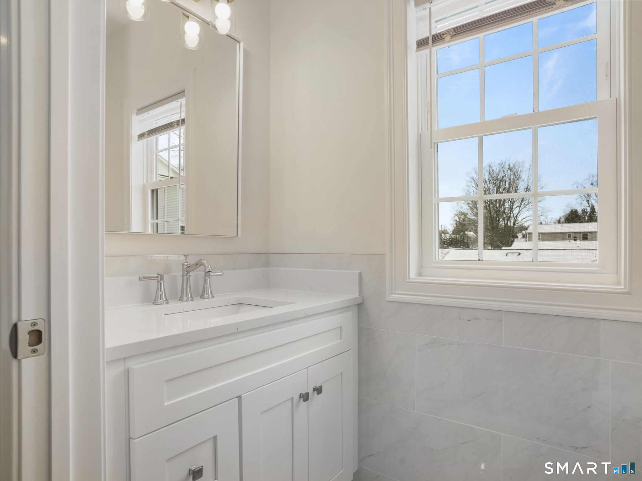 6 Beacon Square, Unit 7 Fairfield, CT 06825 - Photo 23 of 33 a bathroom with a sink a vanity and a large mirror