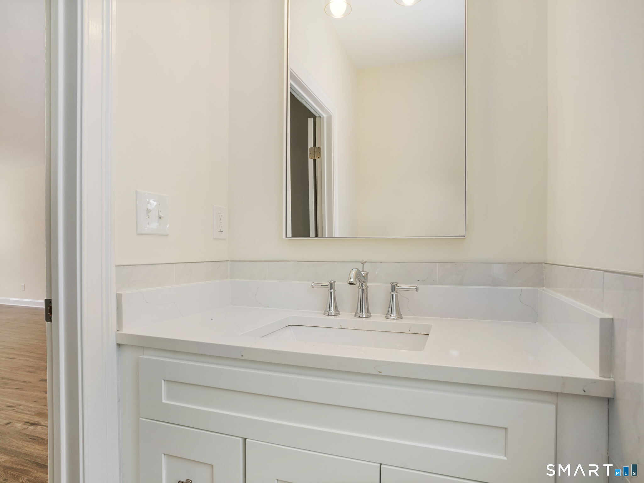 6 Beacon Square, Unit 7 Fairfield, CT 06825 - Photo 26 of 33 a bathroom with a sink and a mirror