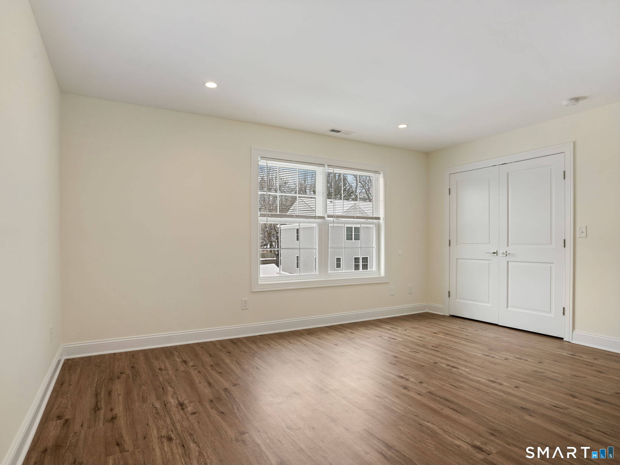 6 Beacon Square, Unit 7 Fairfield, CT 06825 - Photo 27 of 33 an empty room with wooden floor and window
