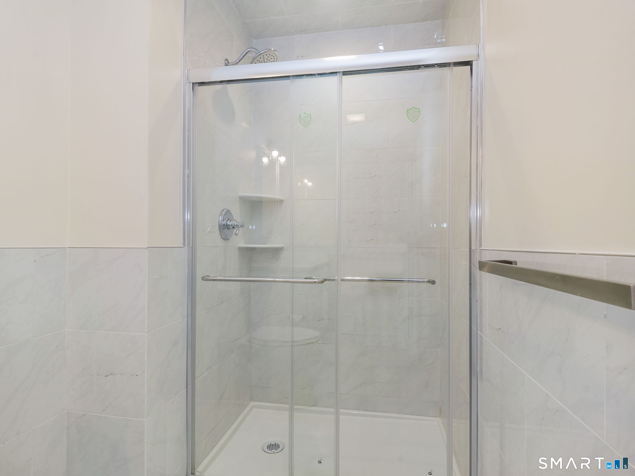 6 Beacon Square, Unit 7 Fairfield, CT 06825 - Photo 30 of 33 a bathroom with a glass shower door