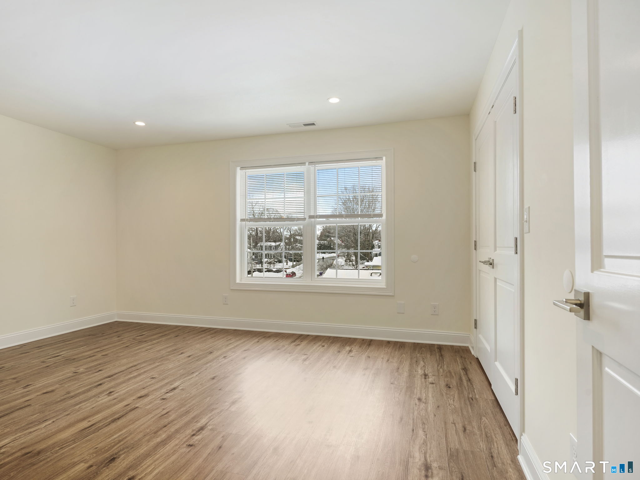 6 Beacon Square, Unit 7 Fairfield, CT 06825 - Photo 33 of 33 an empty room with wooden floor and windows