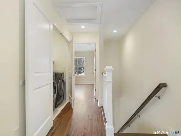 a view of a hallway with a washer and dryer