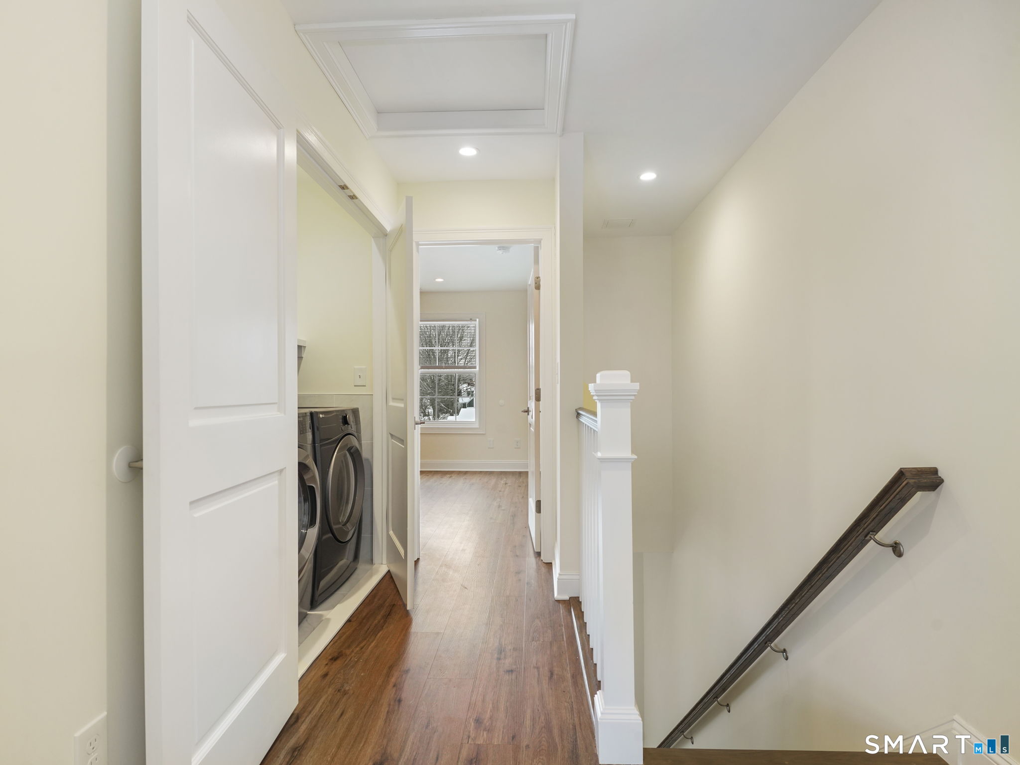 6 Beacon Square, Unit 7 Fairfield, CT 06825 - Photo 6 of 33 a view of a hallway with a washer and dryer