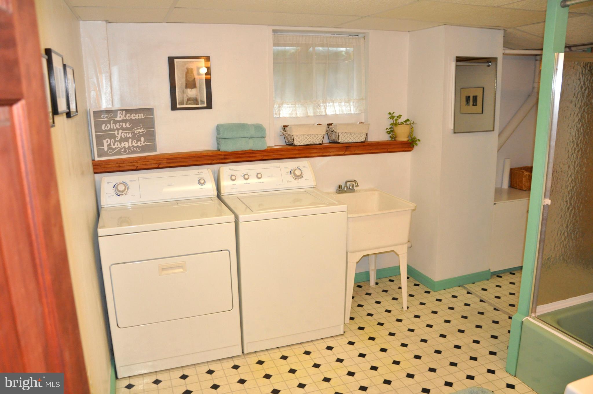 1108 Overbrook Road Baltimore, MD 21239 - Photo 14 of 20 a bathroom with a sink a toilet a shower and a mirror