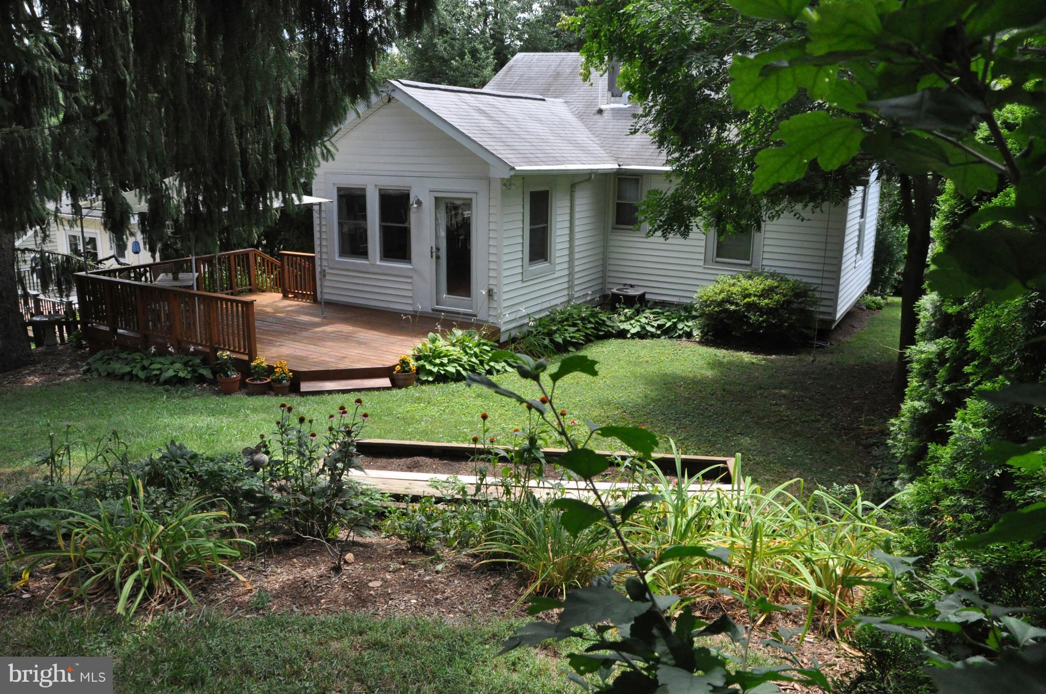 1108 Overbrook Road Baltimore, MD 21239 - Photo 18 of 20 a front view of a house with a yard and potted plants