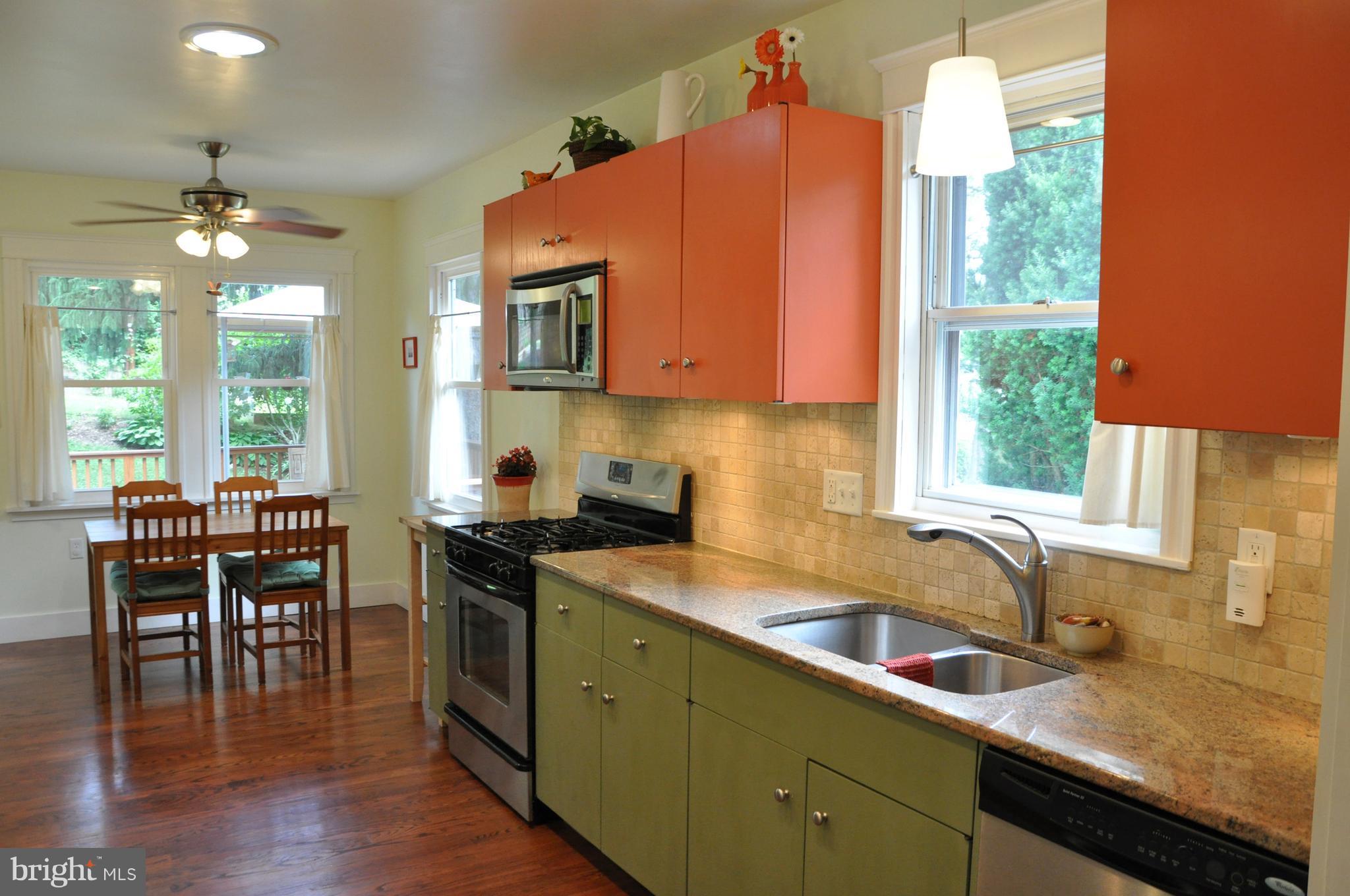 1108 Overbrook Road Baltimore, MD 21239 - Photo 4 of 20 a kitchen with a sink a window and dining table