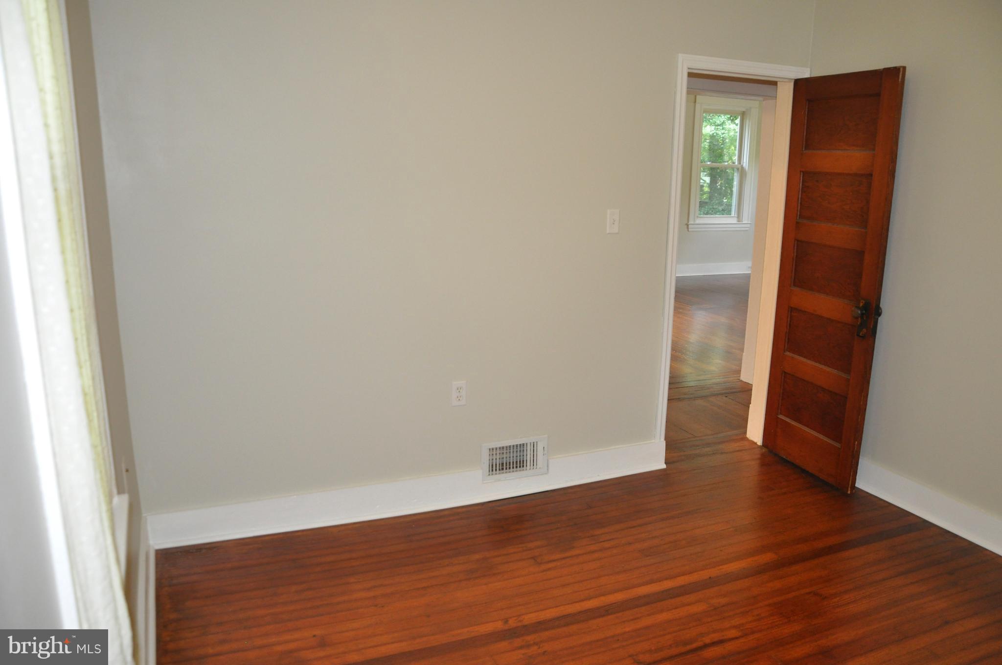 1108 Overbrook Road Baltimore, MD 21239 - Photo 9 of 20 a view of an empty room with wooden floor