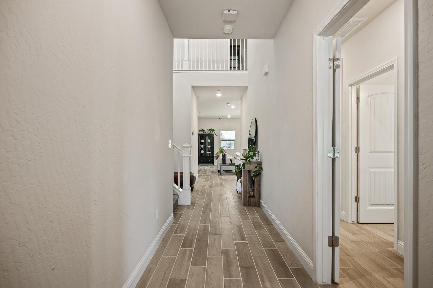 315 Timberline Way Madera, CA 93636 - Photo 5 of 75 a view of a hallway with wooden floor and staircase