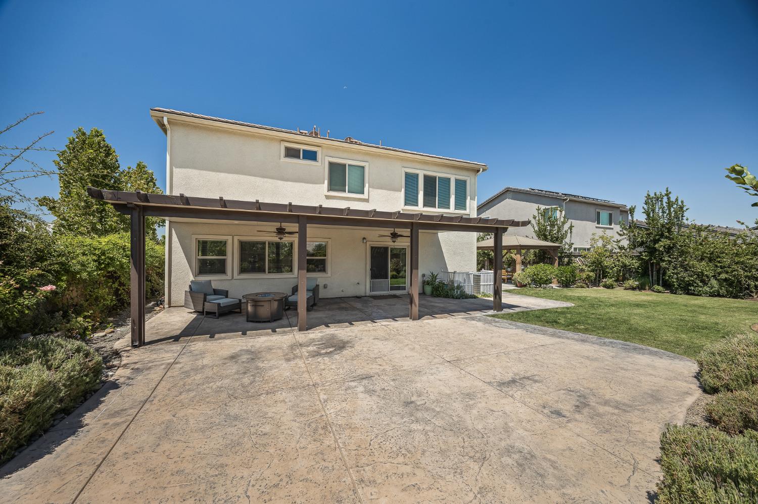315 Timberline Way Madera, CA 93636 - Photo 58 of 75 a view of a house with backyard porch and sitting area
