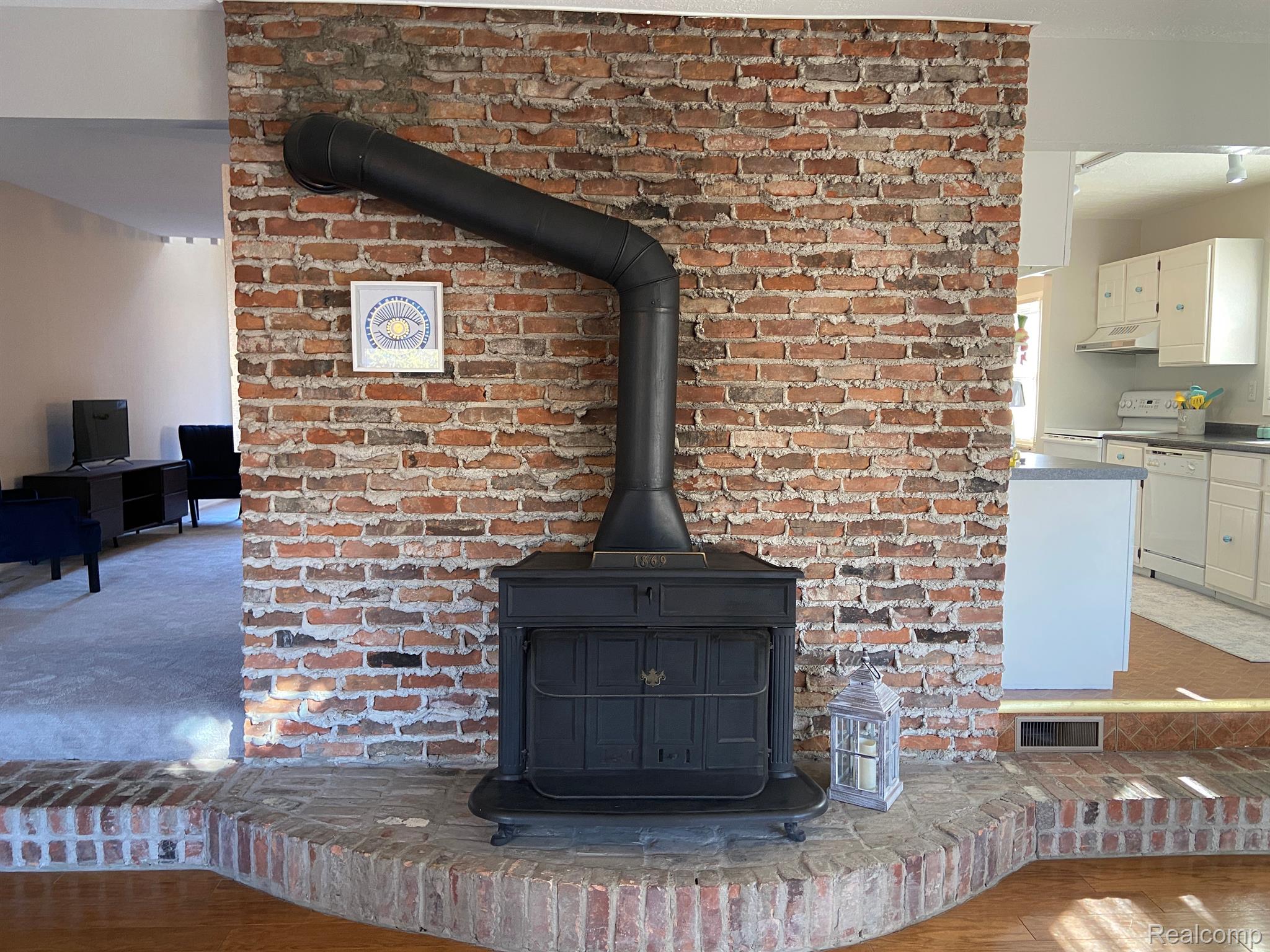 5045 North Crooks Road, Unit 20 Royal Oak, MI 48073 - Photo 11 of 46 Fireplace in Great Room against brick wall.