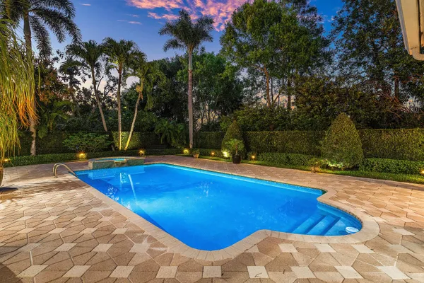 a living room with furniture and a painting on the wall