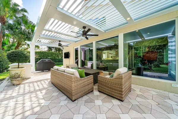 a view of a dining room with furniture a chandelier and wooden floor
