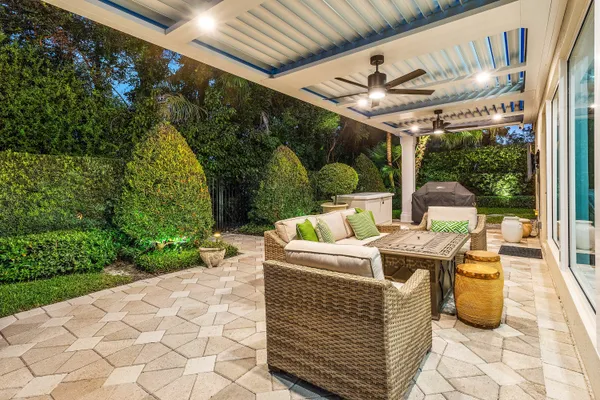 a kitchen with stainless steel appliances a table and chairs in it