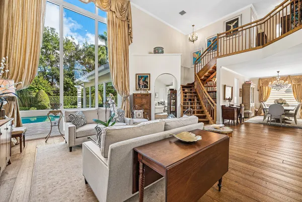 a living room with furniture and a floor to ceiling window