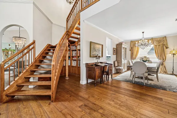 a living room with furniture a flat screen tv and a floor to ceiling window