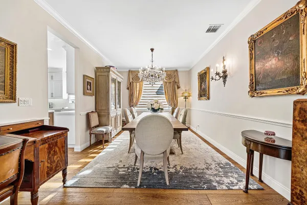 a spacious bedroom with a bed and a chandelier