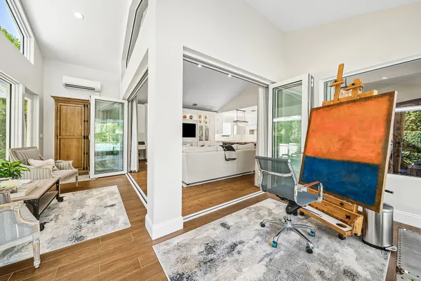 a view of a swimming pool with a chair and potted plants