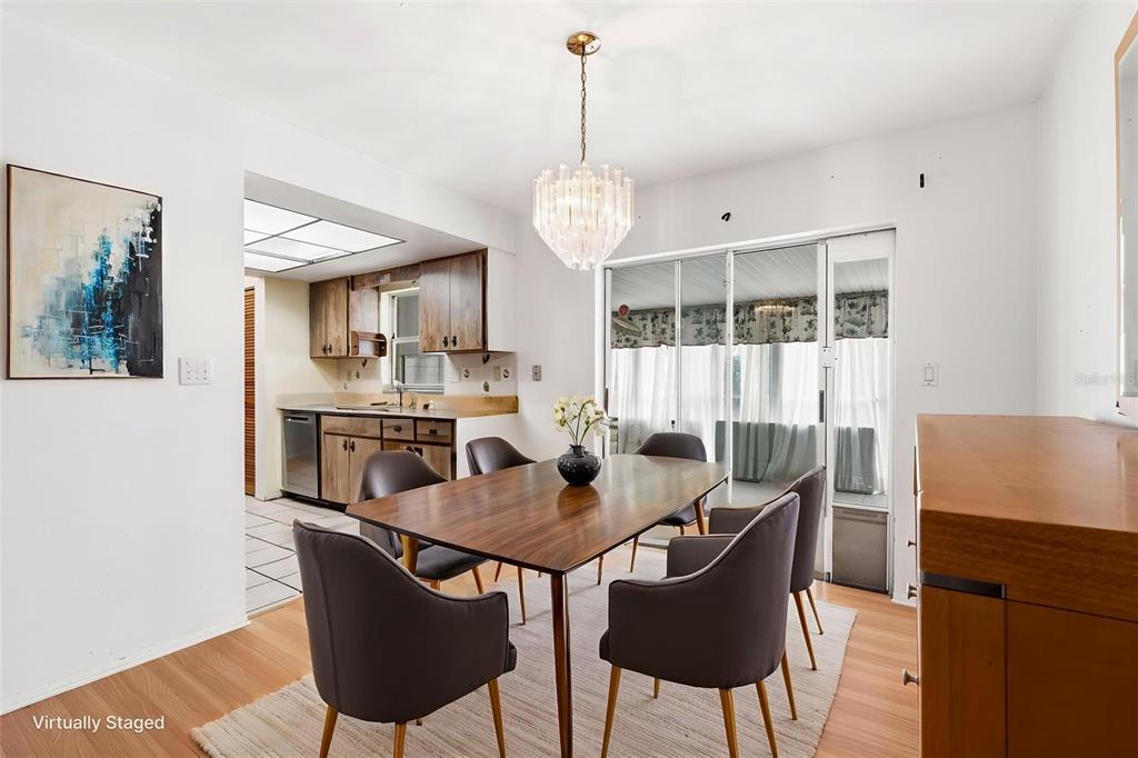 2101 Broad Ranch Drive Port Charlotte, FL 33948 - Photo 12 of 39 a dining room with furniture a chandelier and wooden floor
