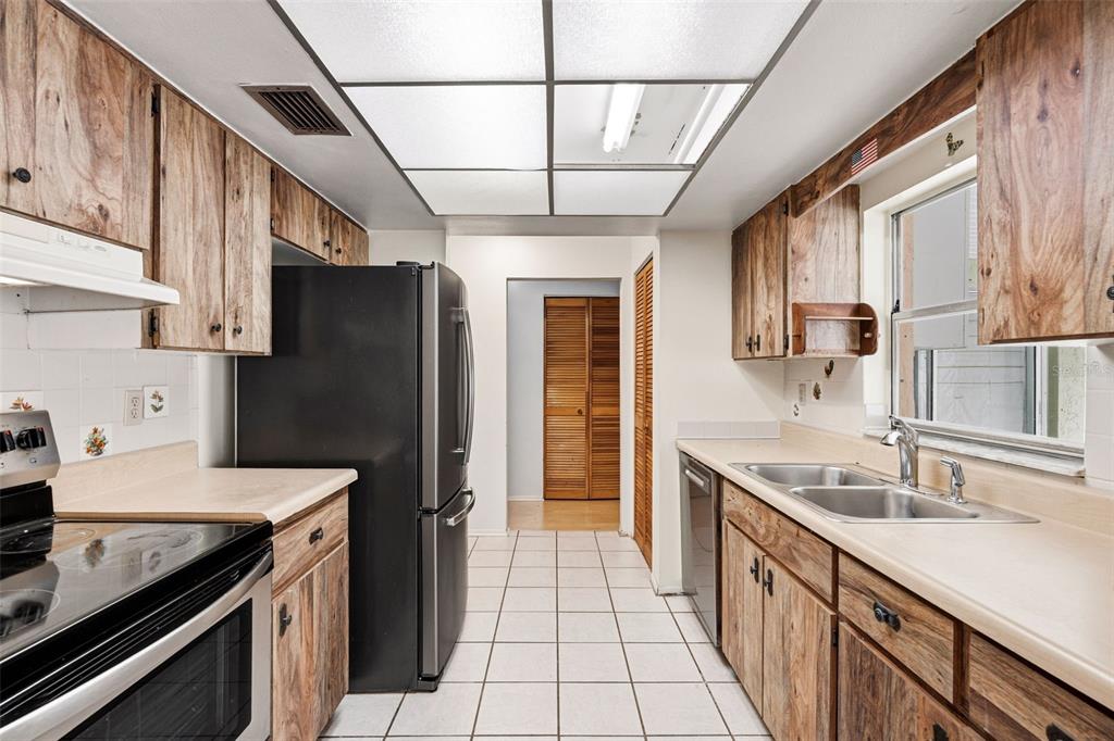 2101 Broad Ranch Drive Port Charlotte, FL 33948 - Photo 15 of 39 a kitchen with stainless steel appliances granite countertop a sink stove and refrigerator