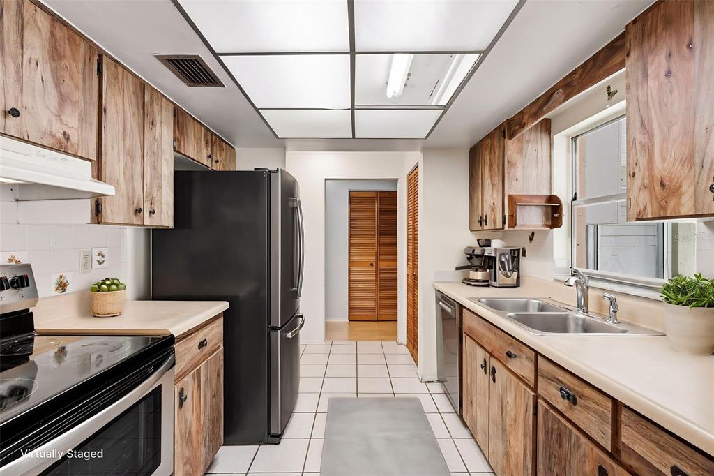 2101 Broad Ranch Drive Port Charlotte, FL 33948 - Photo 16 of 39 a kitchen with stainless steel appliances granite countertop a sink stove and refrigerator