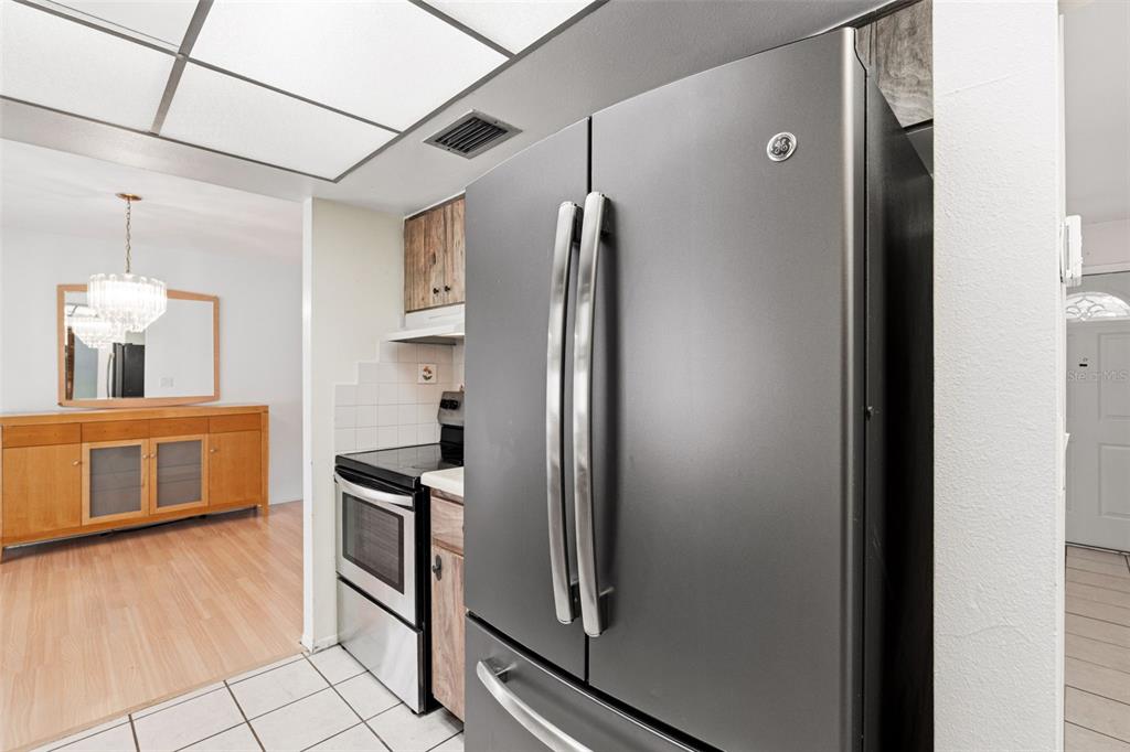 2101 Broad Ranch Drive Port Charlotte, FL 33948 - Photo 18 of 39 a kitchen with stainless steel appliances granite countertop a refrigerator and a stove top oven