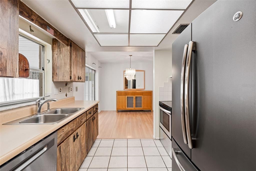 2101 Broad Ranch Drive Port Charlotte, FL 33948 - Photo 19 of 39 a kitchen with stainless steel appliances a sink stove and refrigerator