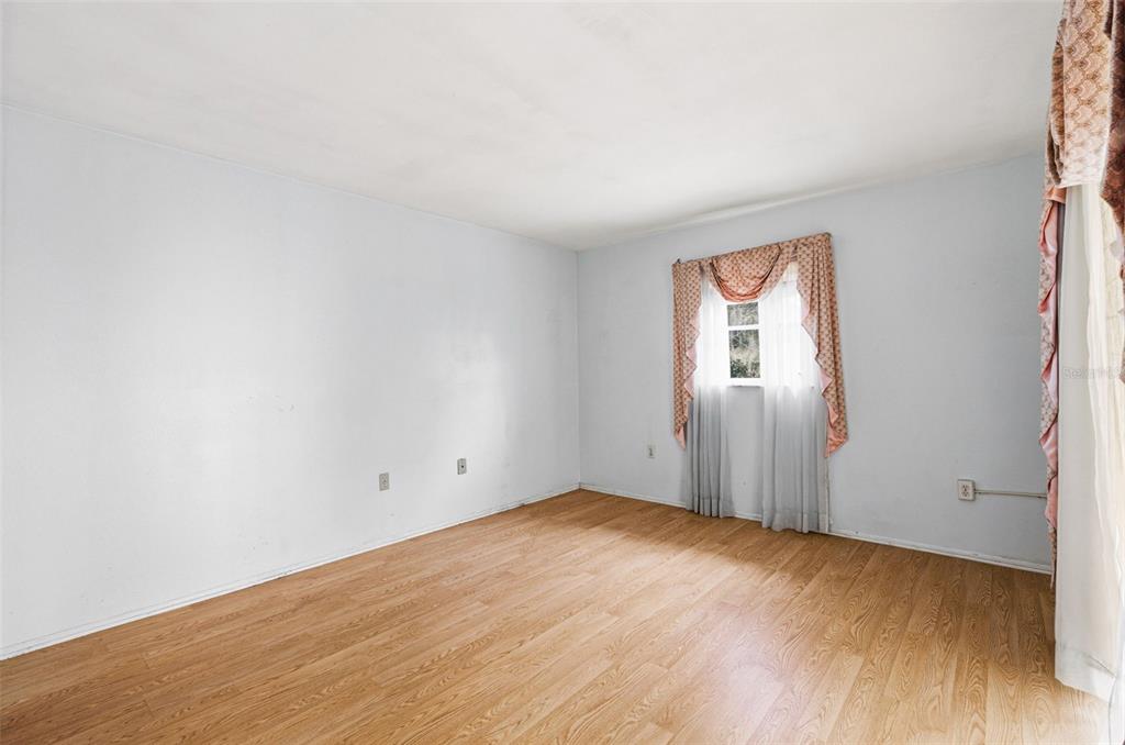 2101 Broad Ranch Drive Port Charlotte, FL 33948 - Photo 20 of 39 an empty room with wooden floor and windows