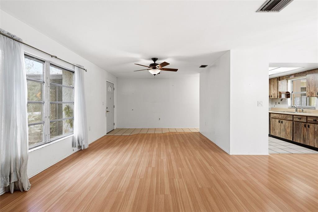 2101 Broad Ranch Drive Port Charlotte, FL 33948 - Photo 23 of 39 wooden floor in an empty room with a window