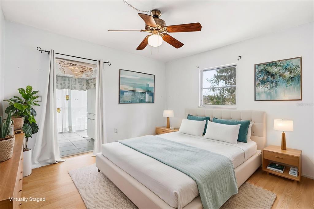 2101 Broad Ranch Drive Port Charlotte, FL 33948 - Photo 26 of 39 a bedroom with a large bed and a chandelier