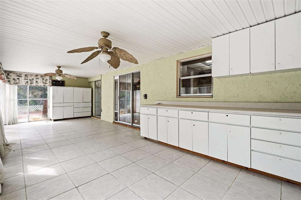 2101 Broad Ranch Drive Port Charlotte, FL 33948 - Photo 30 of 39 a garage with white cabinets and ceiling fan