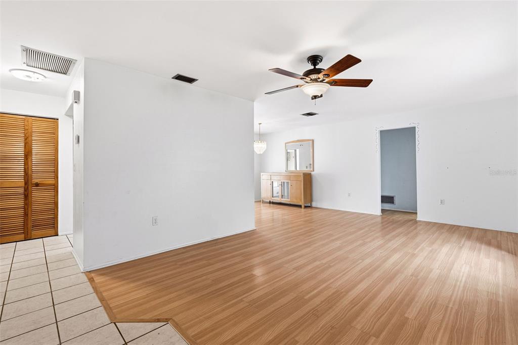 2101 Broad Ranch Drive Port Charlotte, FL 33948 - Photo 6 of 39 wooden floor in an empty room with a window